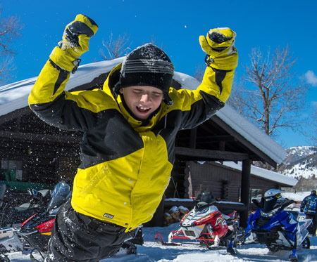 Snowmobiling child having fun