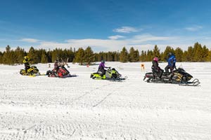 Snowmobilers riding on the trail