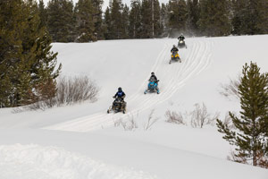 Snowmobilers riding on the trail