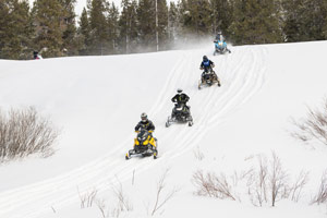 Snowmobilers riding on the trail