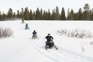 Snowmobilers riding on the trail