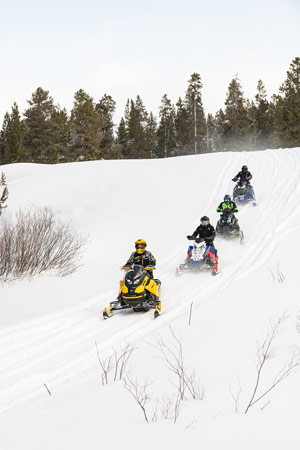 Snowmobilers riding on the trail