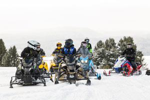 Snowmobilers riding on the trail