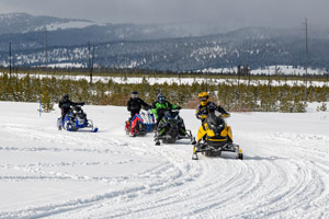 Snowmobilers riding on the trail