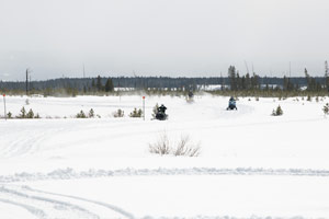 Snowmobilers riding on the trail