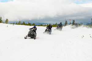 Snowmobilers riding on the trail