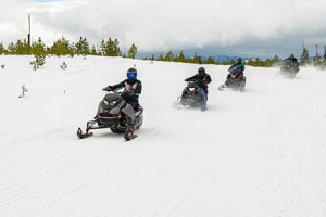 Snowmobilers riding on the trail