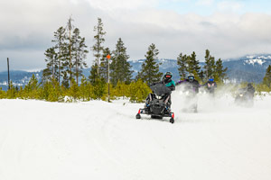 Snowmobilers riding on the trail