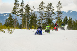 Snowmobilers riding on the trail