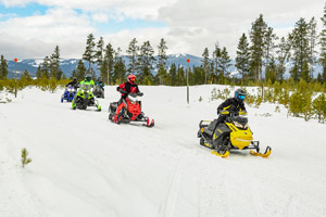 Snowmobilers riding on the trail