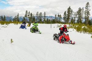 Snowmobilers riding on the trail