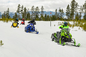 Snowmobilers riding on the trail