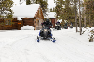 Snowmobilers riding on the trail