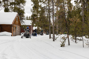 Snowmobilers riding on the trail