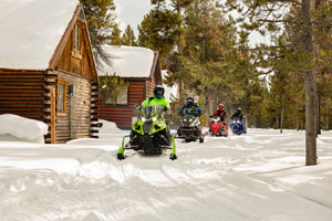 Snowmobilers riding on the trail