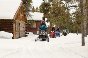 Snowmobilers riding on the trail