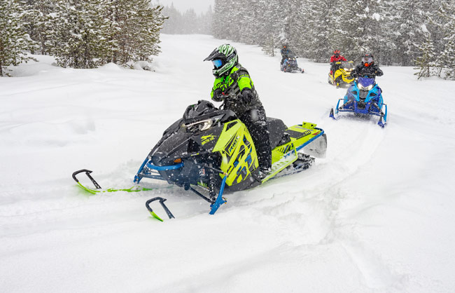 Photos of snowmobilers riding trail in snow