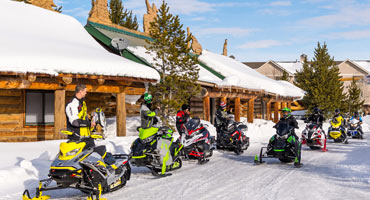 Snowmobilers outside a local snowmobiling lodge