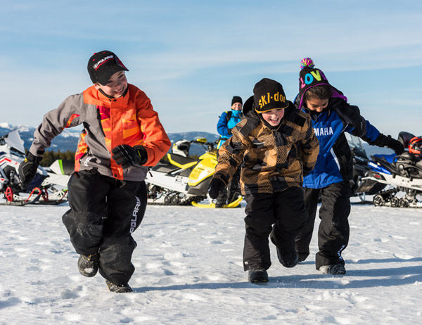 Young men snowmobiling